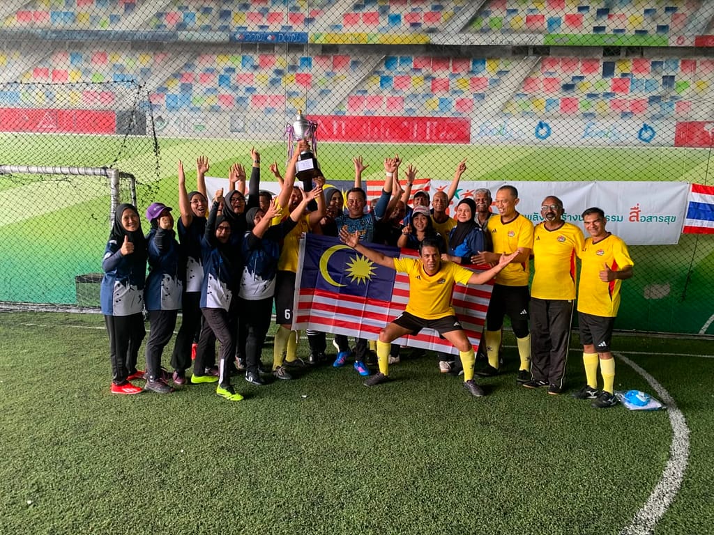 STRIDES Walking Football Club celebrating their championship win in Bangkok